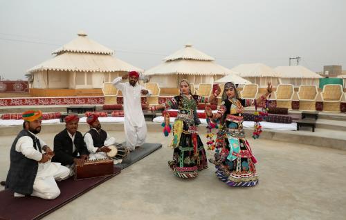 a group of people in traditional dress posing for a picture at Bhavya Resort - Luxury Boutique Desert Camp in Jaisalmer