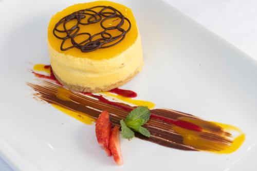 a dessert on a white plate with a piece of cake at Saints Bay Hotel in St Martin Guernsey