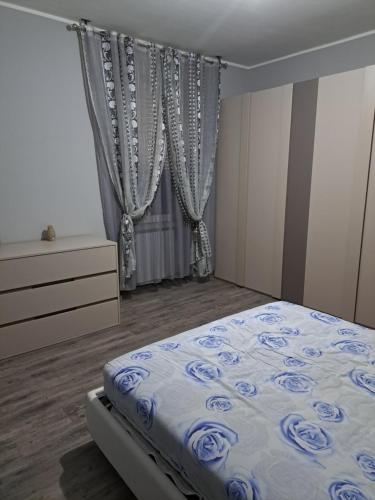 a bedroom with a bed and a dresser and a window at Welcome home in Terni