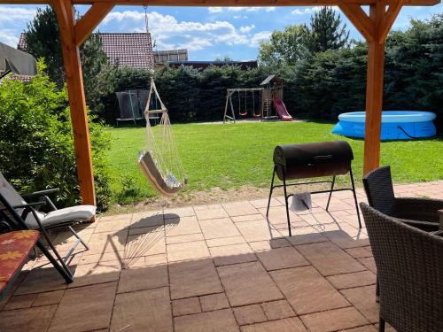 a patio with a swing and a playground at Holiday Raj in Bešeňová