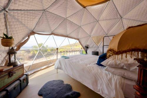 a bedroom in a tent with a bed and a window at Starry Starry Night in Montagu