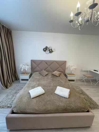a bedroom with a large bed with two pillows on it at V&G Apartment in Lviv