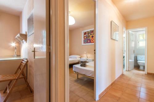 a room with a bathroom with a bed and a toilet at Illes Medes a el Golfet in Palafrugell