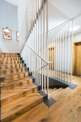 a staircase in a house with wooden floors at Jaśmin Apartamenty in Krynica Zdrój