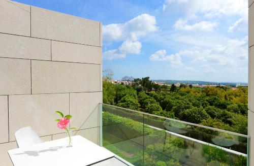 a room with a balcony with a vase on a table at Pousada Palacio de Estoi – Small Luxury Hotels of the World in Estói