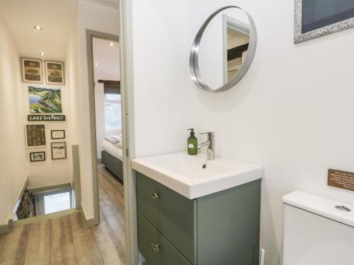 a bathroom with a sink and a mirror on the wall at Turn Cottage in Ulverston