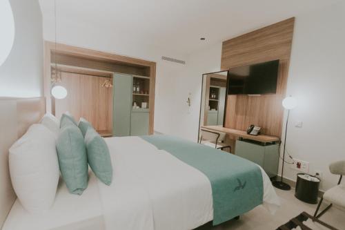 Un ou plusieurs lits dans un hébergement de l'établissement Catalina Plaza Hotel Sostenible