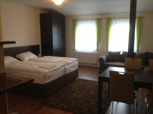 a bedroom with a bed and a living room at Hotel Sport Mlada Boleslav in Mladá Boleslav