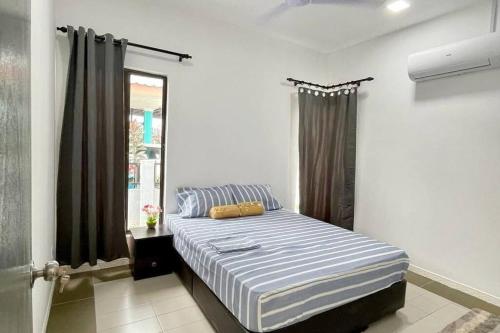 - une chambre avec un lit dans une pièce dotée d'une fenêtre dans l'établissement Inderaloka Villa 23A Free Parking, à Shah Alam