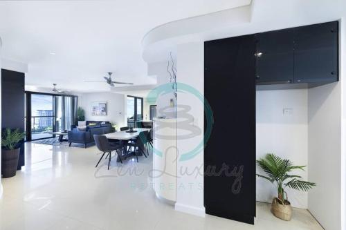 a living room with a dining room and a kitchen at ZEN AT ARKABA 3BR Luxury Waterfront Apt Pool + BBQ in Darwin