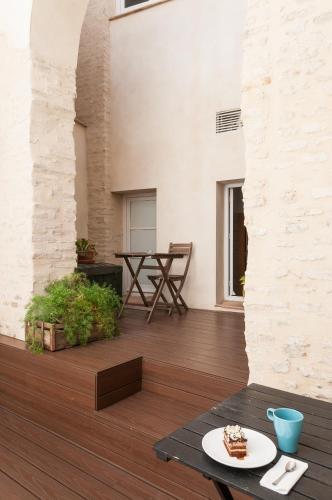 a patio with a table with a plate of food on it at The Nomad Hostel&Pension in Seville