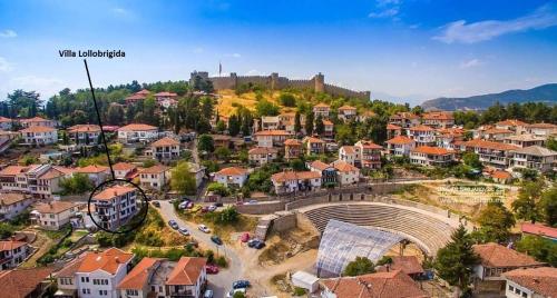 a town with a castle on a hill with houses at Villa Lollobrigida in Ohrid