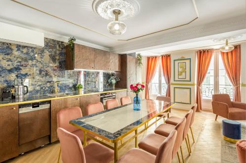 a kitchen with a dining room table and chairs at Luxury 4 bedrooms 3 bathrooms apartment - Louvre in Paris
