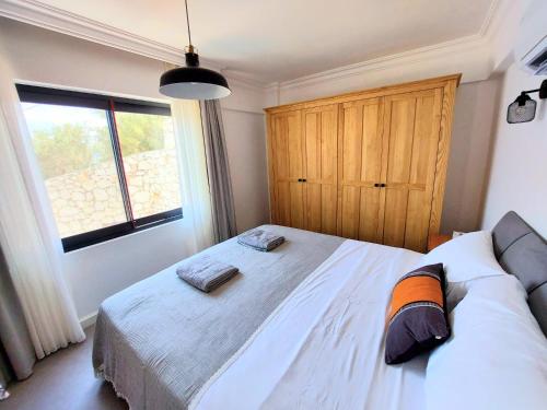 a bedroom with a large bed and a large window at Ece Hotel Sovalye Island in Fethiye