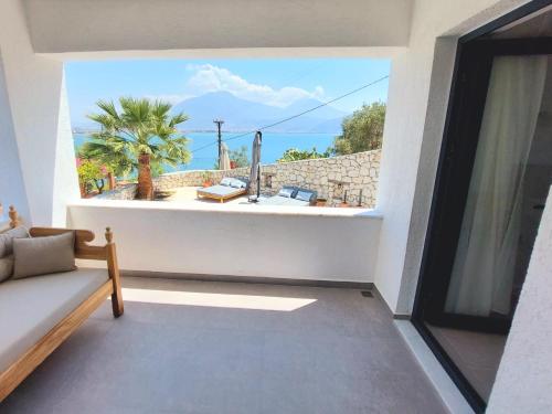 a living room with a view of the ocean at Ece Hotel Sovalye Island in Fethiye