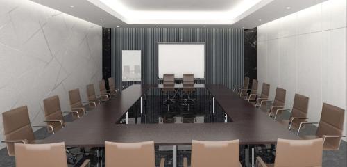 a conference room with a long table and chairs at Hotel Santika Batam in Batam Center