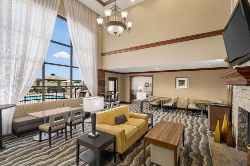 a living room with a couch and chairs and a fireplace at Staybridge Suites Oklahoma City-Quail Springs by IHG in Oklahoma City