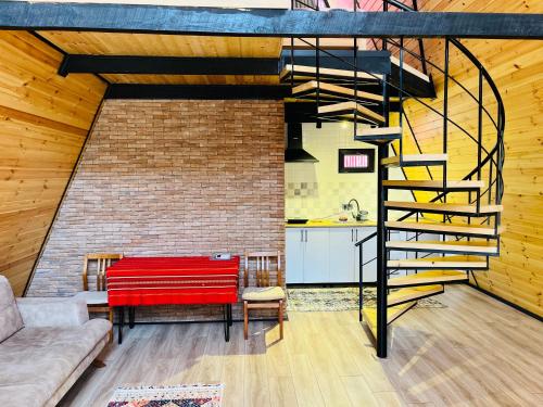 a living room with a red bench and a brick wall at A-Frame Kobuleti in K'obulet'i