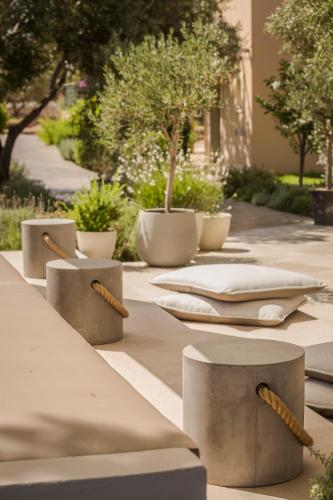 a long table with napkins and plants on it at Thalassa Boutique Hotel - Adults Only in Lassi