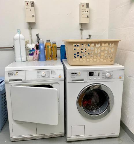 a laundry room with a washer and a washing machine at FeWo Fuchs Saig in Lenzkirch