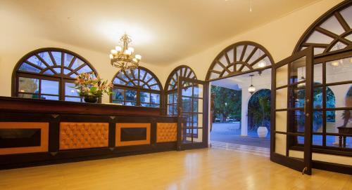 a hallway with arched glass doors and a chandelier at Cocoa Luxury Resort, Nyali, Mombasa in Mombasa