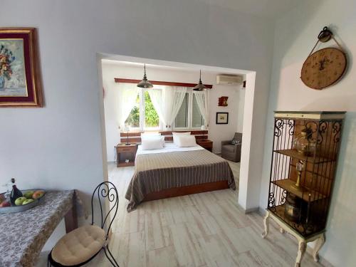 a bedroom with a bed and a chair in a room at City House Apartments in Tivat