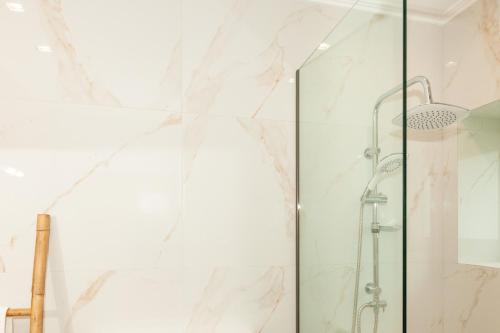 a shower with a glass door at Mylos Mountain Villas- Villa Giorgio in Agios Nikitas