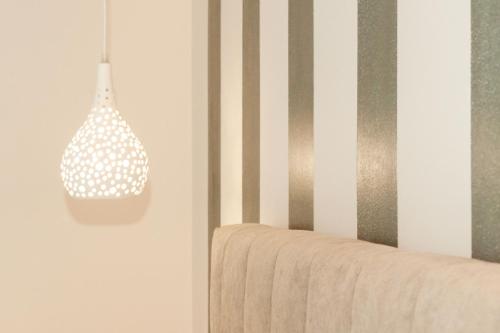 a pendant light hanging from a wall in a room at Mylos Mountain Villas- Villa Giorgio in Agios Nikitas