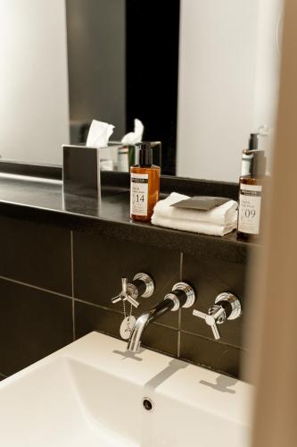 a bathroom with a sink and a mirror at ABode Chester in Chester