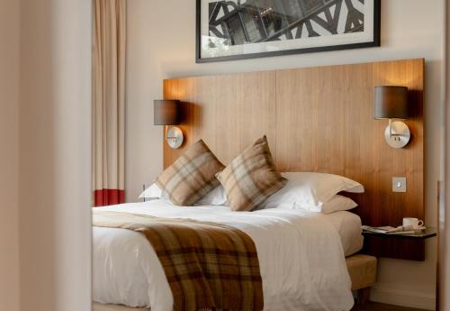 a bedroom with a large bed with white sheets and pillows at ABode Chester in Chester