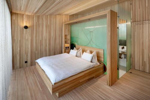 a bedroom with a large bed and a glass door at Hotel Glocke in Reckingen - Gluringen