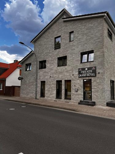 a brick building with a sign on the side of it at Grand Hotel in Soltau