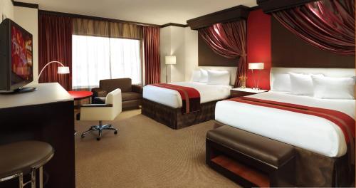 a hotel room with two beds and two lamps at Ameristar Casino Hotel in East Chicago