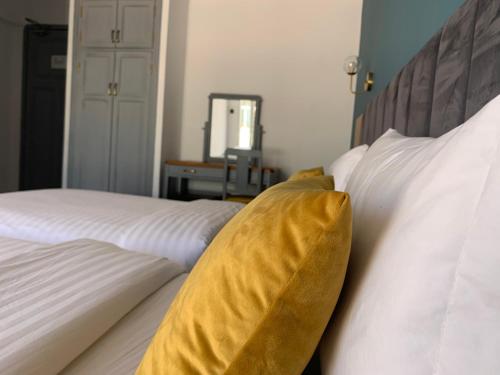 a yellow blanket sitting on top of two white beds at Royal Hotel Rabat in Rabat