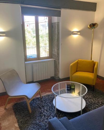 a living room with a couch and a table and a chair at Principale@Brandon in Brandon