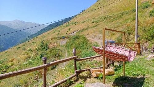 a wooden fence on the side of a hill at Qaldea Resort in Ushguli