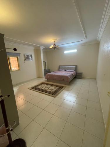 a bedroom with a bed in the middle of a room at شقة الشرقي 1 in Abha