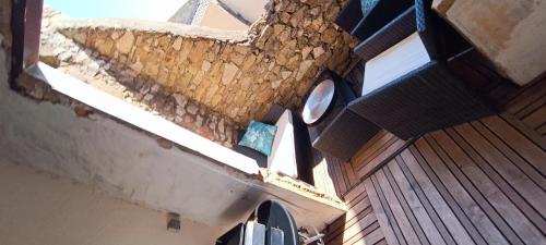 a building with a roof with a clock on it at Agréable maison de village in Laudun