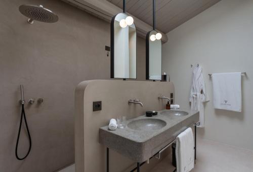 a bathroom with a sink and a mirror at Palazzo Tafuri Boutique Hotel in Nardò