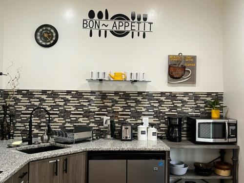 a kitchen with a counter top with a microwave at Uber Close to Ohio City, Cleveland (Lower) in Cleveland