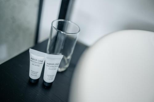 two tubes of moisturizing cream sitting on a table at MyHotel Steenwijk - Giethoorn in Steenwijk