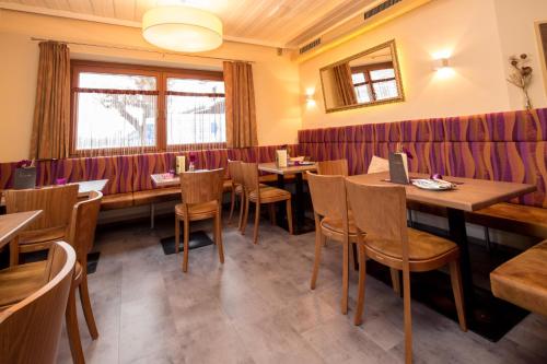 a dining room with wooden tables and chairs at Pension La Mamma in Aschach an der Donau