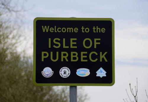 a sign that says welcome to the isle of purbeck at Magnolia Passageway to the Jurassic Coast. in Stoborough