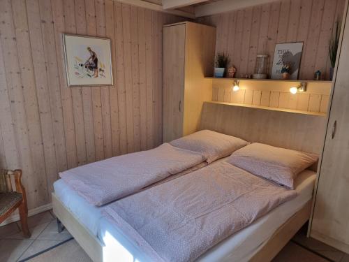 a bed in a room with two pillows on it at Haus Sandra in Baabe