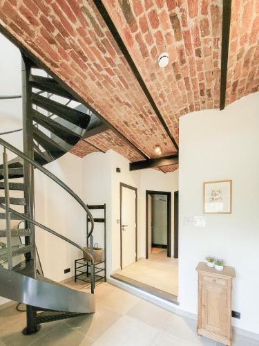 a brick ceiling in a room with a staircase at Au bout de mes rêves in Walcourt