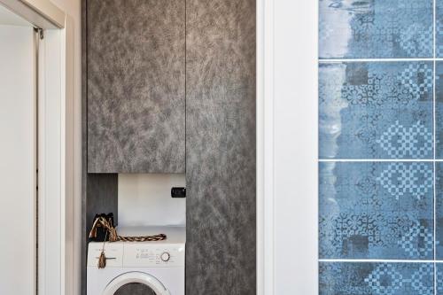 a laundry room with a washer and dryer at Le Chicche del Porto - Allure in Genova