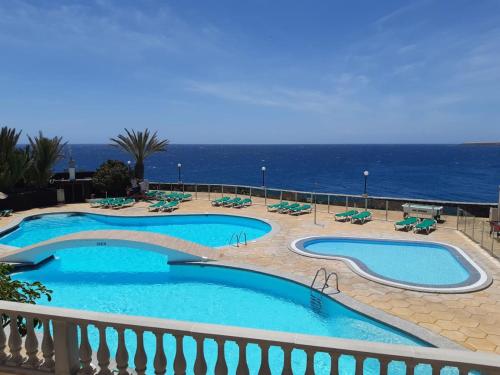 a swimming pool with a view of the ocean at Westhaven Bay in Costa Del Silencio