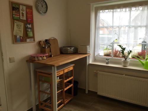 a kitchen with a counter and a window at Ferienwohnung "Am Radweg" in Telgte