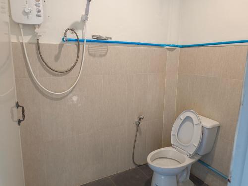 a bathroom with a shower and a toilet in it at sunny in town in Pai