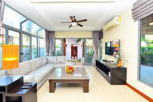a living room with a white couch and a table at 74 Patong villa walk to Bangla Rd in 10min 3 room cozy modern style in Patong Beach